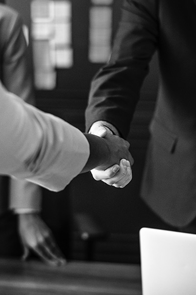 black and white photo of two people shaking hands